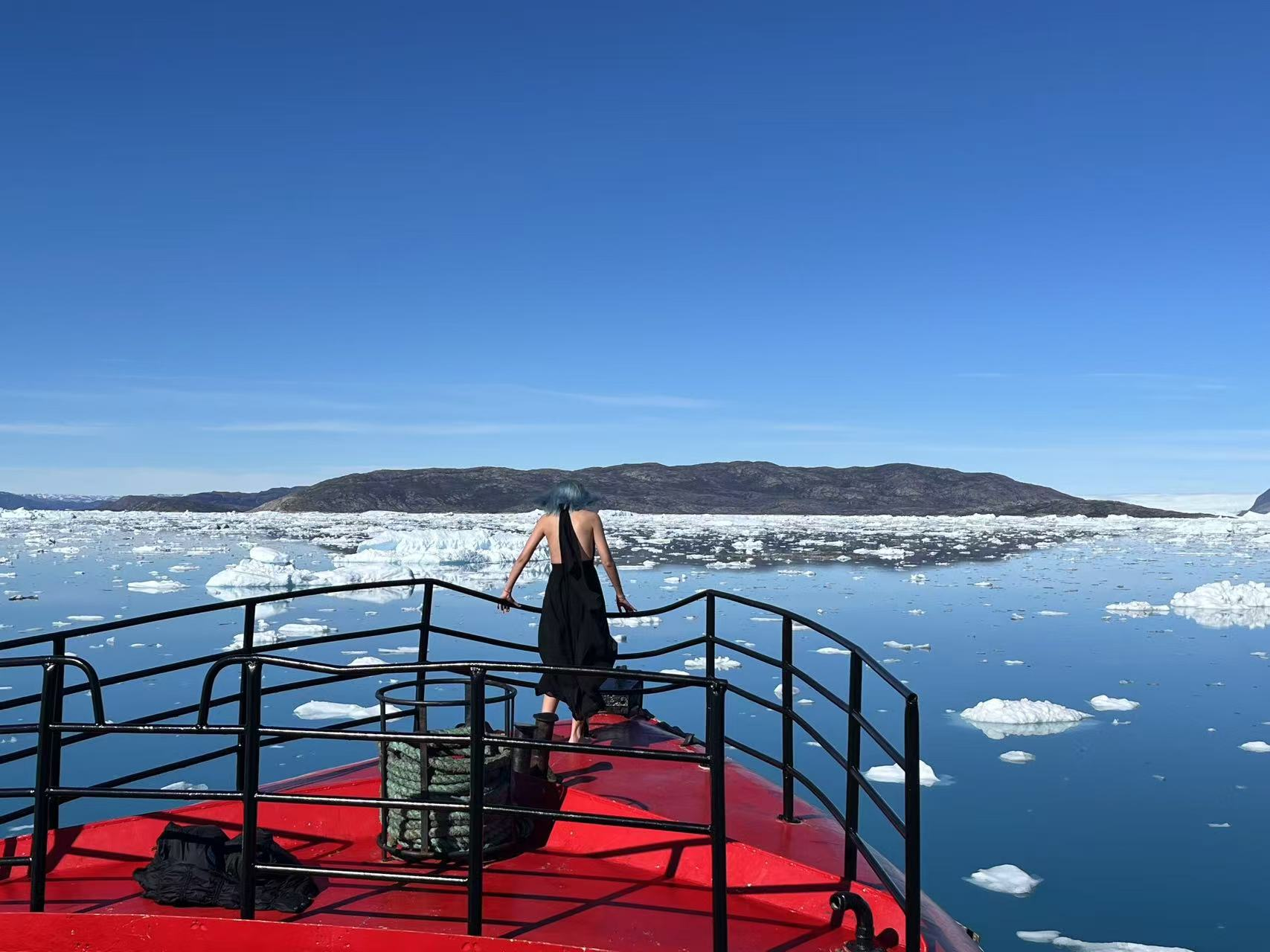 从船头望向平静海面与远方冰山，引人内省